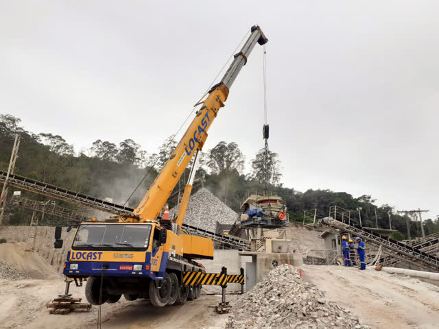 Guindaste telescópico da Locast içando um britador em uma pedreira